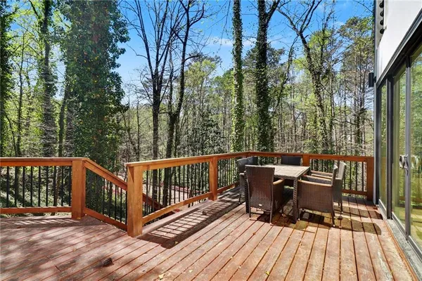 a view of a deck with two chairs and wooden floor