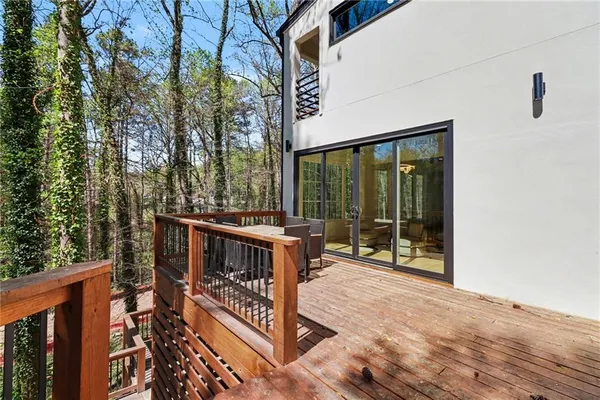a view of a deck with chairs and wooden fence