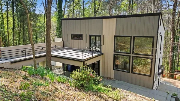 a view of a house with backyard and balcony