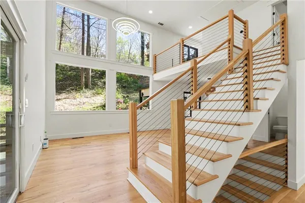 a view of entryway and hall with wooden floor