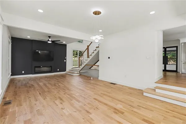 a view of an empty room with wooden floor