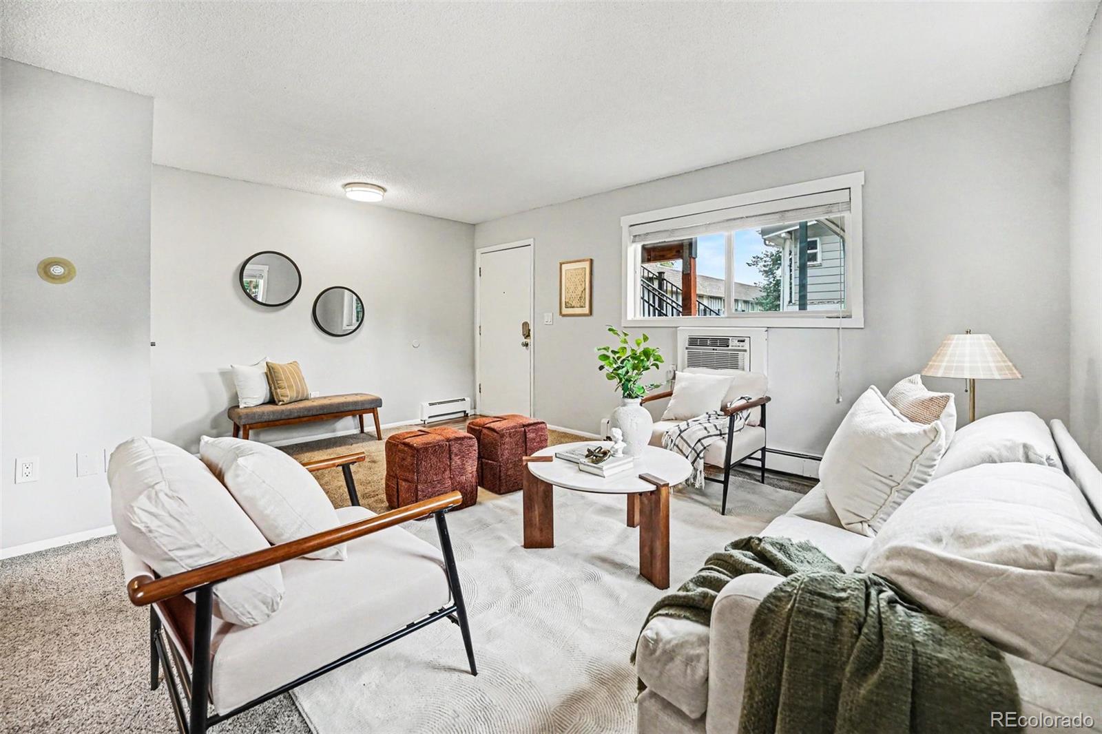 5700 West 28th Avenue, Unit 1 Wheat Ridge, CO 80214 - Photo 5 of 25 a living room with furniture and wooden floor