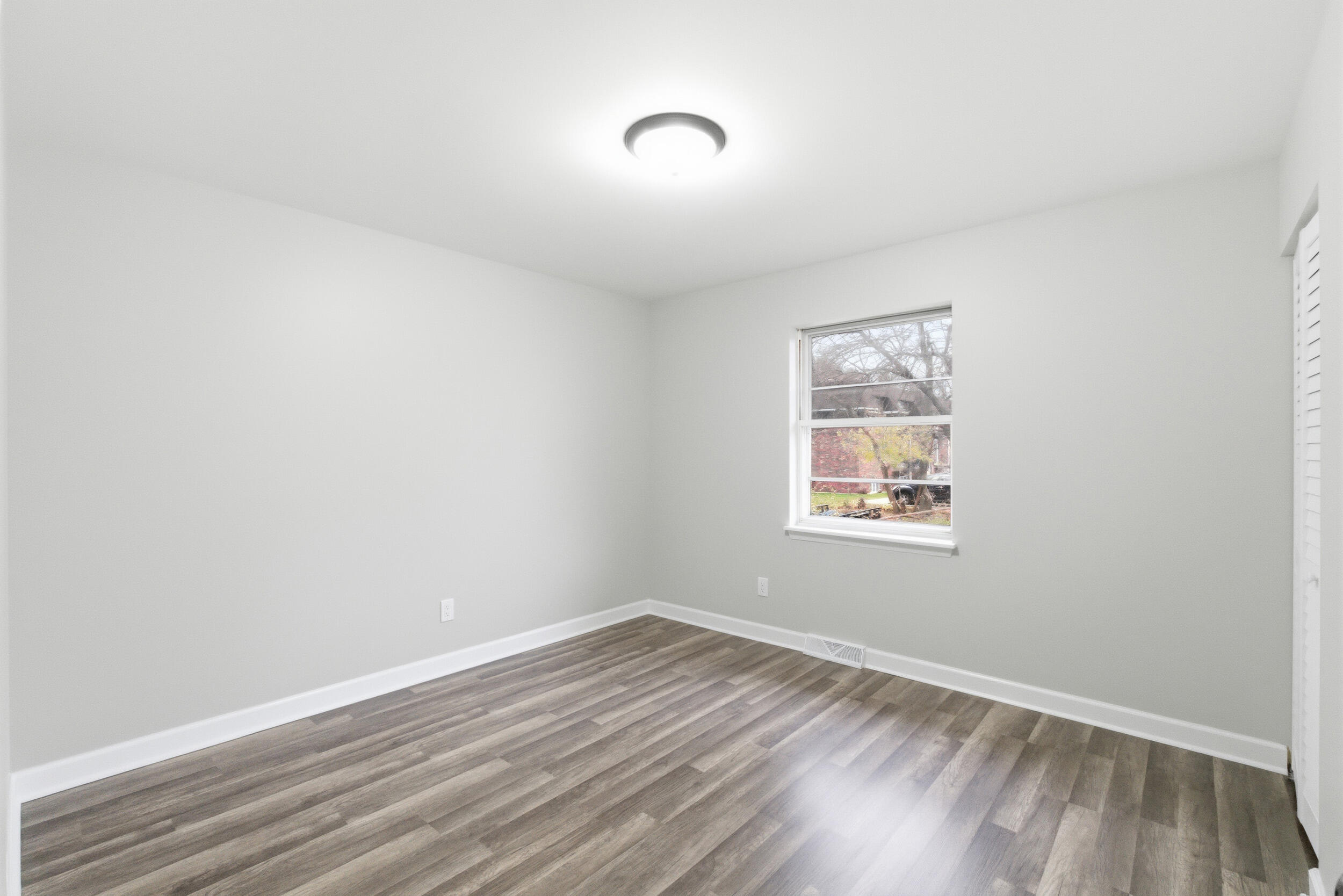 3610 175th Place Hammond, IN 46323 - Photo 12 of 21 a view of an empty room with wooden floor and a window