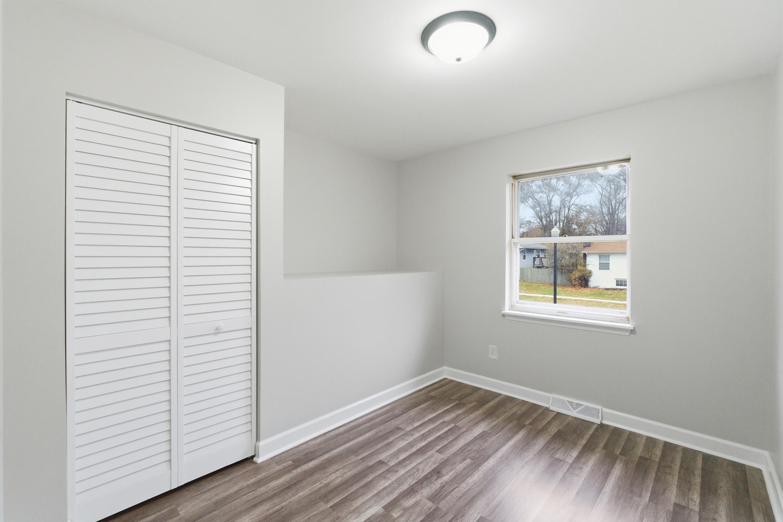 3610 175th Place Hammond, IN 46323 - Photo 13 of 21 an empty room with wooden floor and windows