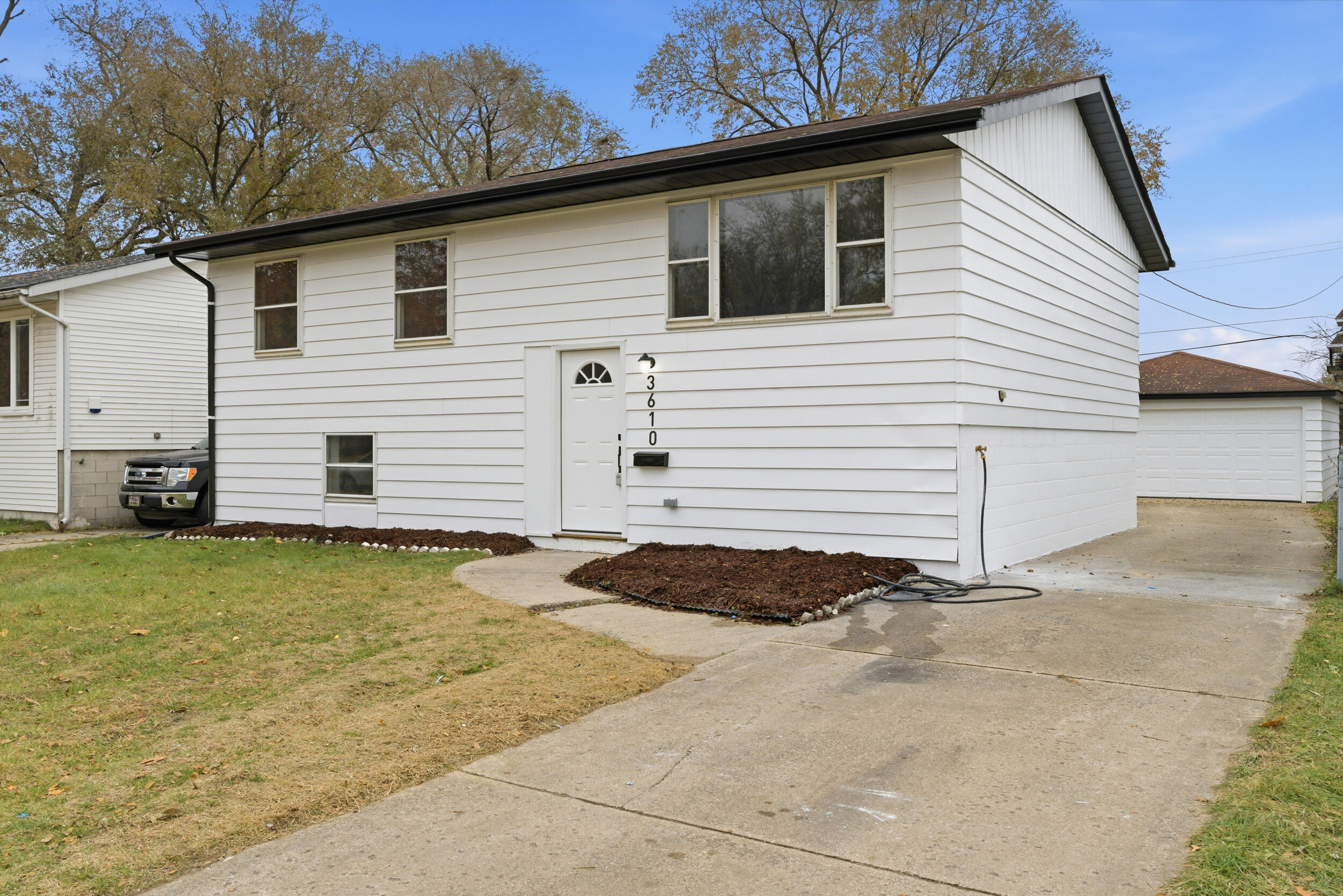 3610 175th Place Hammond, IN 46323 - Photo 2 of 21 a view of a backyard with a barbeque grill and wooden fence