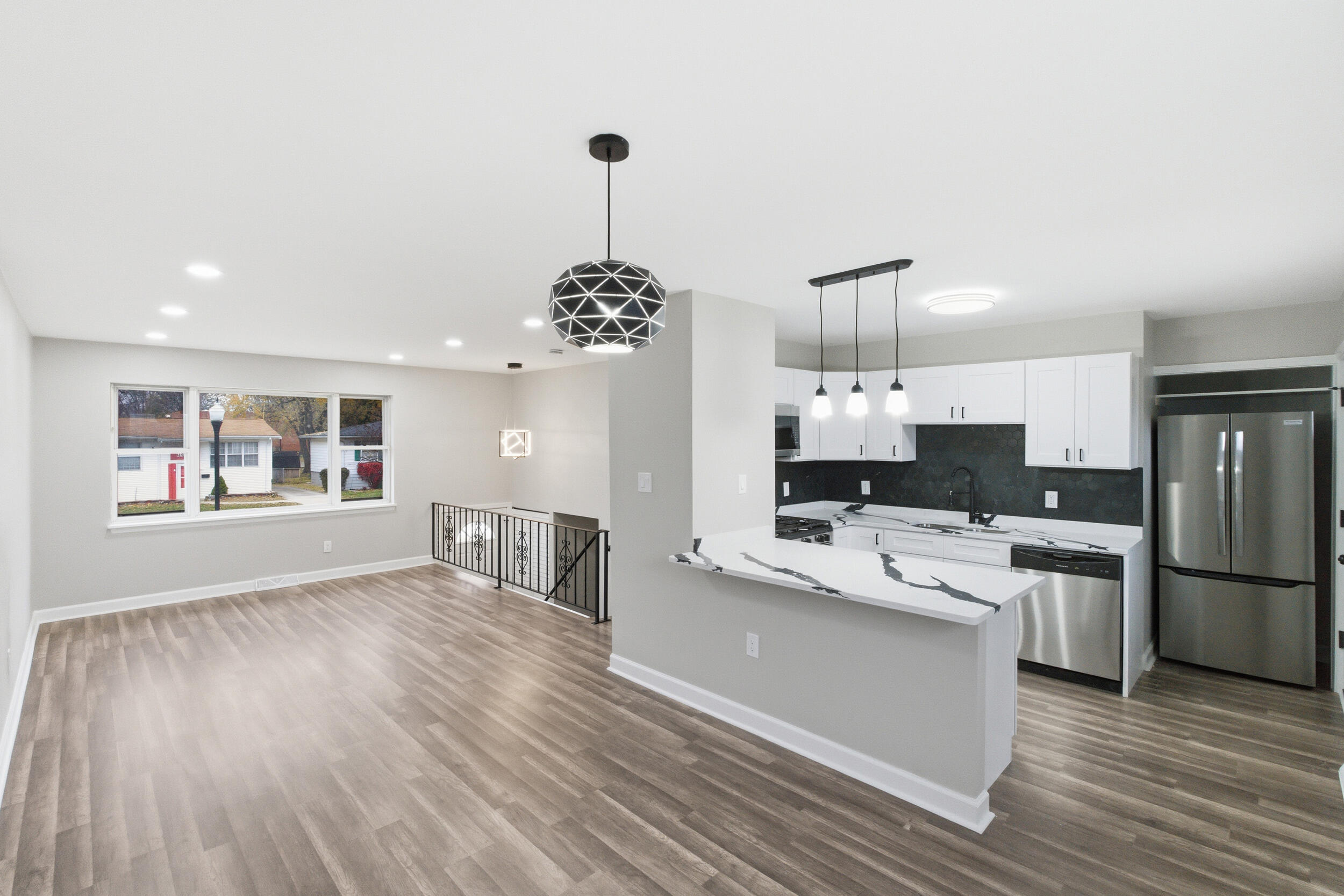 3610 175th Place Hammond, IN 46323 - Photo 5 of 21 a living room with stainless steel appliances kitchen island hardwood floor and a kitchen view