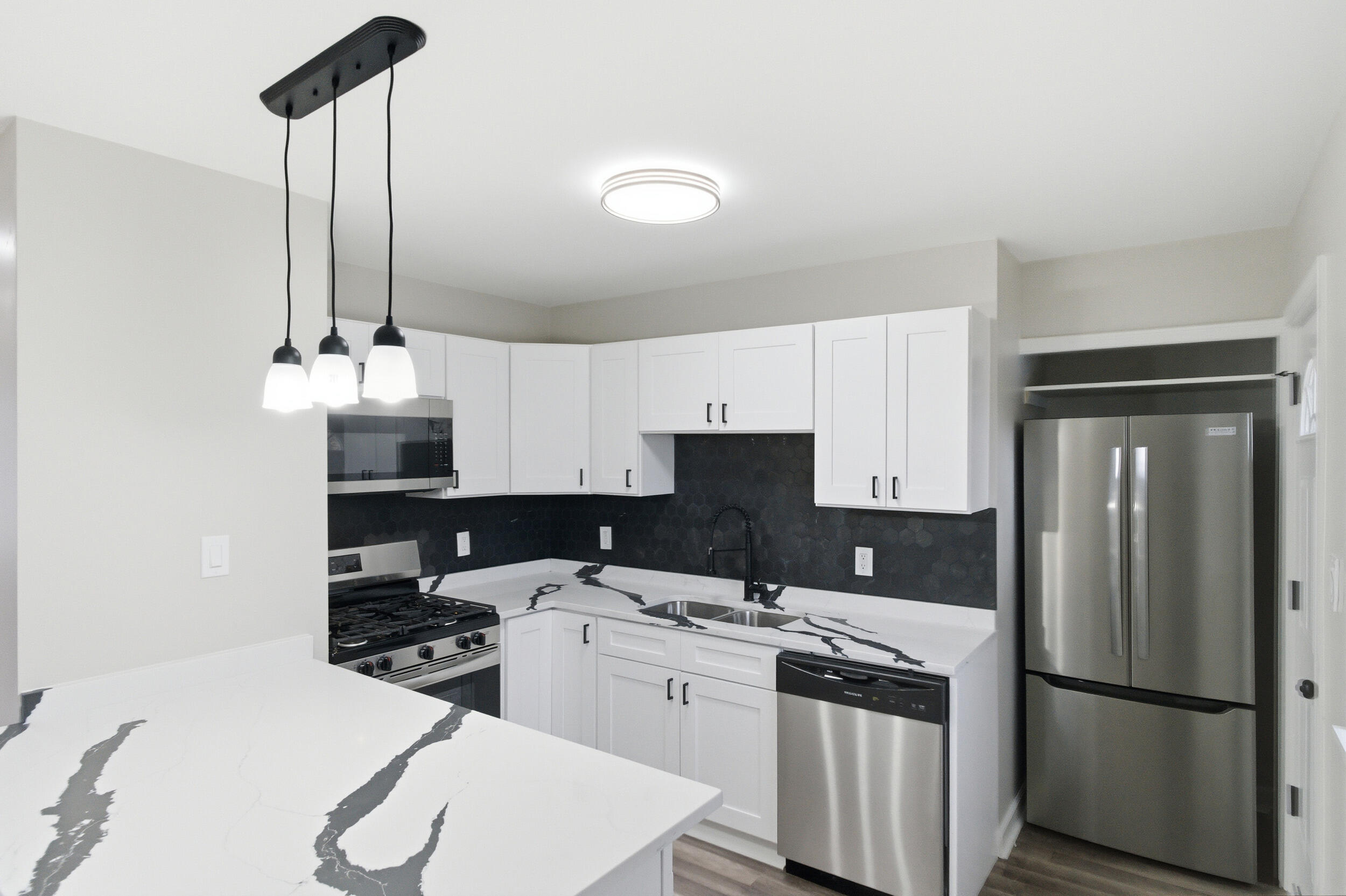 3610 175th Place Hammond, IN 46323 - Photo 6 of 21 a kitchen with a sink refrigerator and cabinets