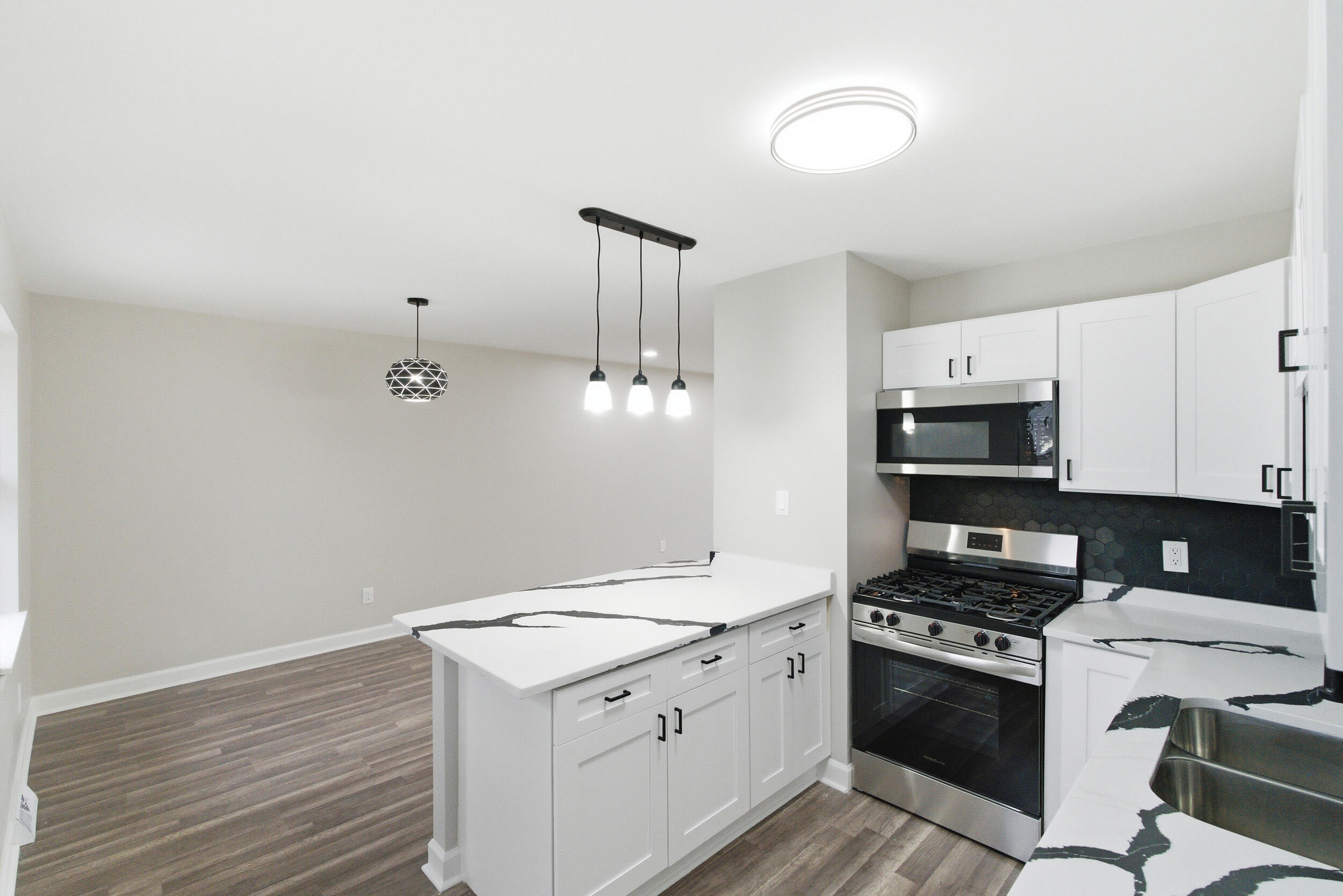 3610 175th Place Hammond, IN 46323 - Photo 8 of 21 a kitchen with granite countertop a sink cabinets and stainless steel appliances