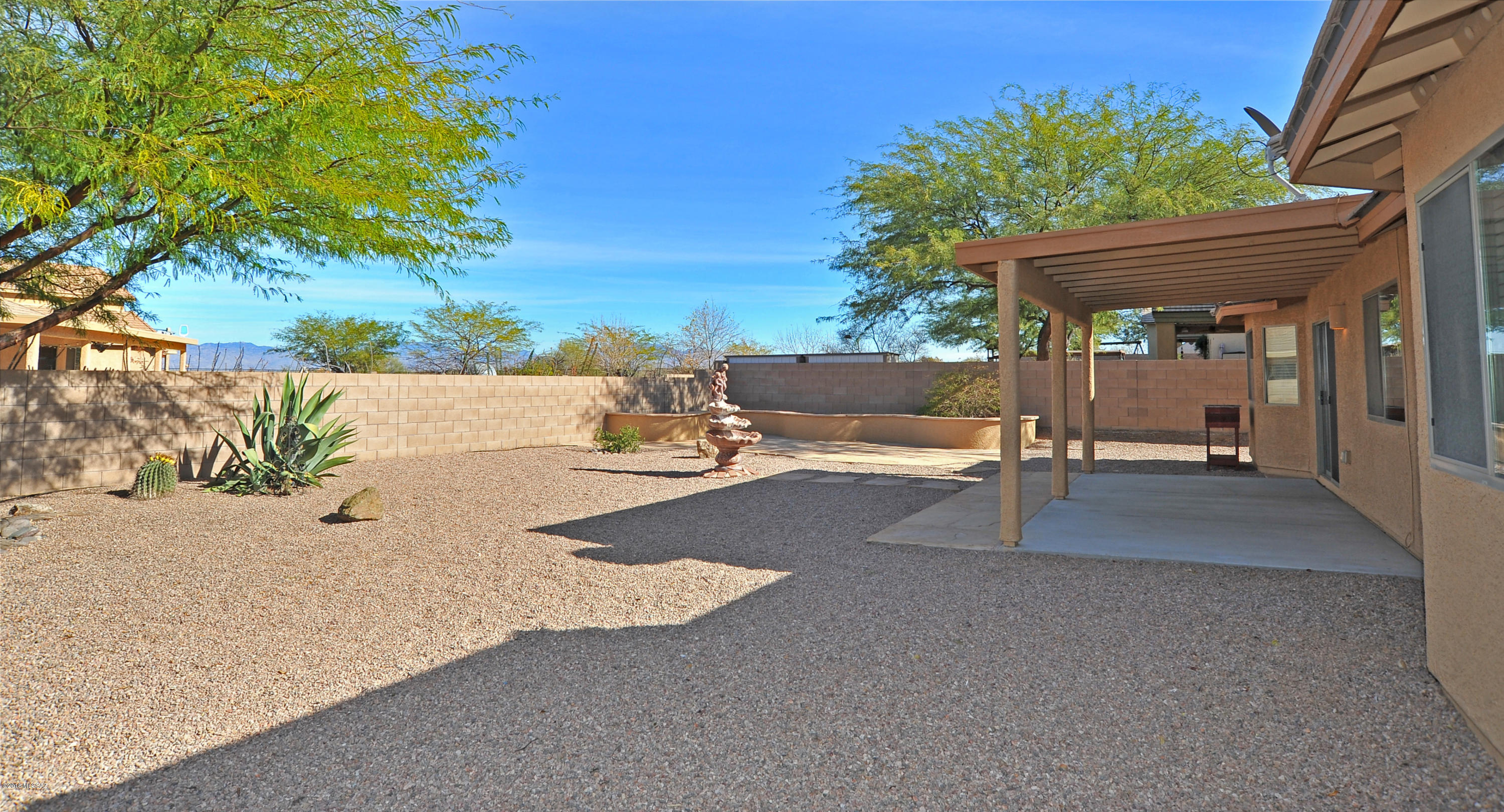 558 West Chatfield Street Vail, AZ 85641 - Photo 4 of 31 a view of a patio with a table and chairs under an umbrella