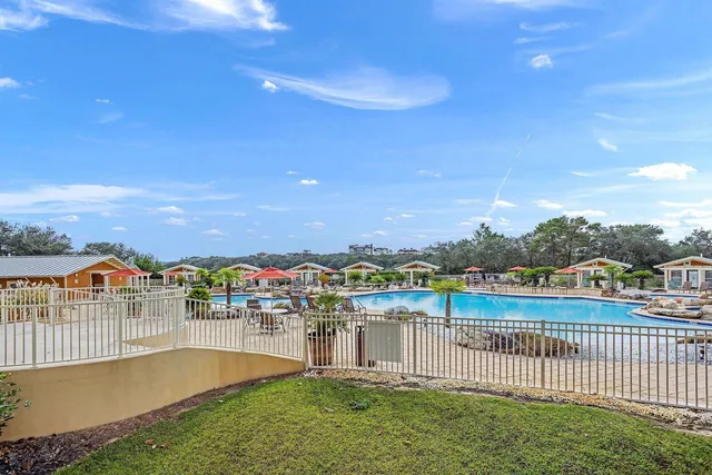 a view of a livingroom with furniture a ceiling fan and wooden floor