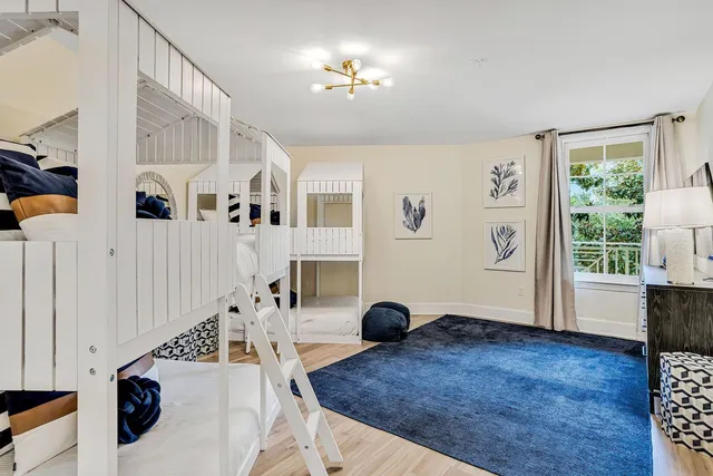 a living room with furniture a flat screen tv and a couch