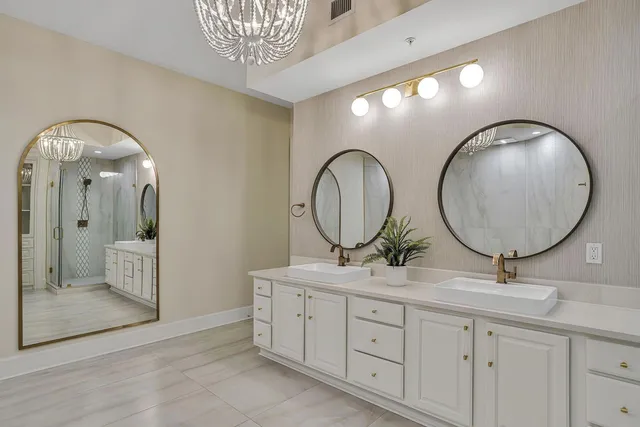 a bedroom with bed and a flat tv screen on dresser