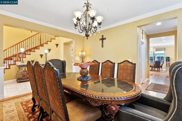 a dining room with furniture and chandelier