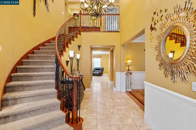 a view of a hallway with wooden floor and entryway