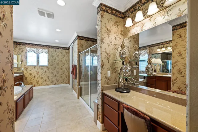 a bathroom with a tub a sink and a large mirror