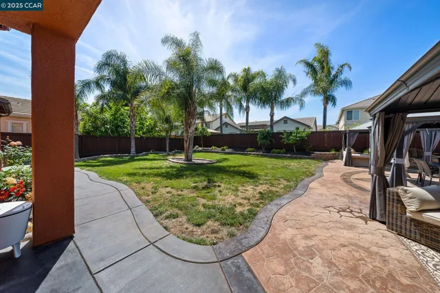 a front view of a house with a yard table and chairs