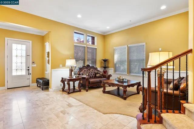 a living room with furniture pool and wooden floor