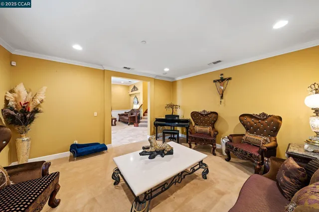 a living room with patio furniture and a potted plant