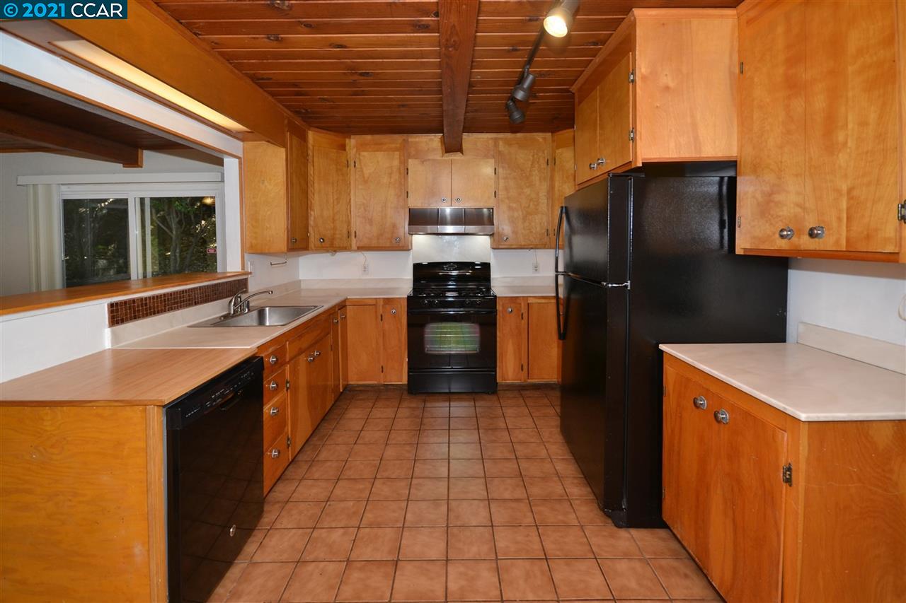 928 Janet Lane Lafayette, CA 94549 - Photo 12 of 35 a kitchen with stainless steel appliances granite countertop a refrigerator a sink a stove with wooden cabinets