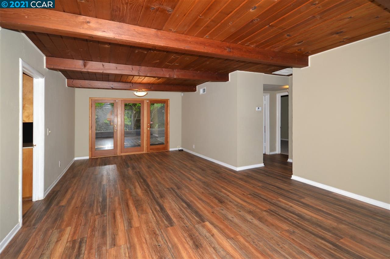 928 Janet Lane Lafayette, CA 94549 - Photo 7 of 35 an empty room with wooden floor and windows
