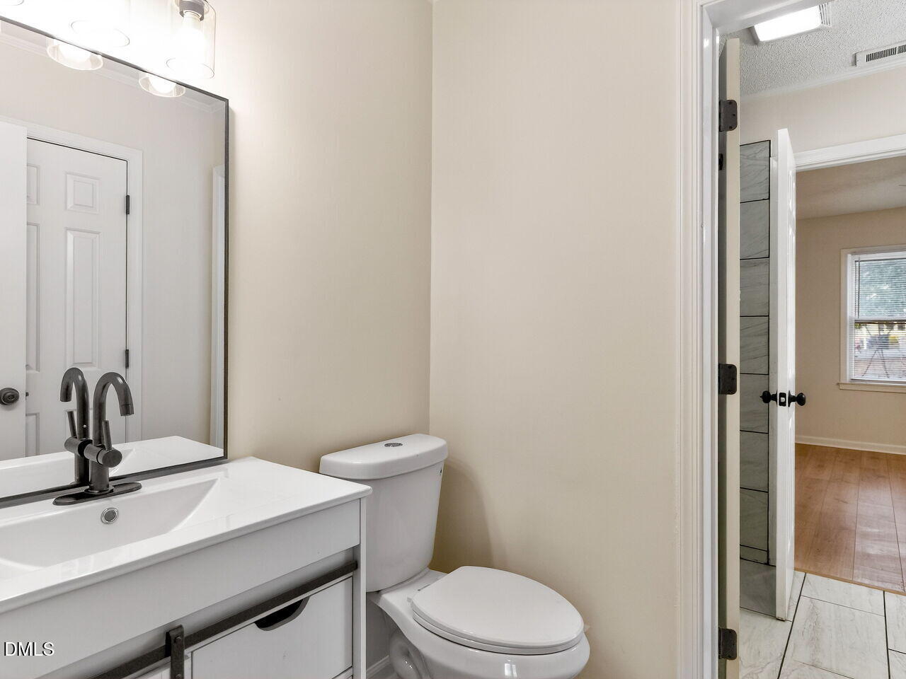 113 Towne View Trail Garner, NC 27529 - Photo 19 of 30 a bathroom with a sink a toilet and mirror