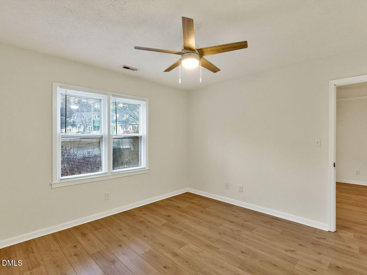 113 Towne View Trail Garner, NC 27529 - Photo 24 of 30 an empty room with wooden floor fan and windows