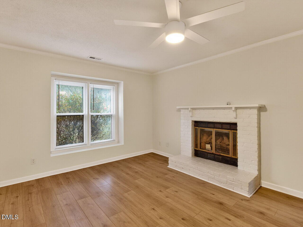 113 Towne View Trail Garner, NC 27529 - Photo 5 of 30 an empty room with windows a fireplace and wooden floor