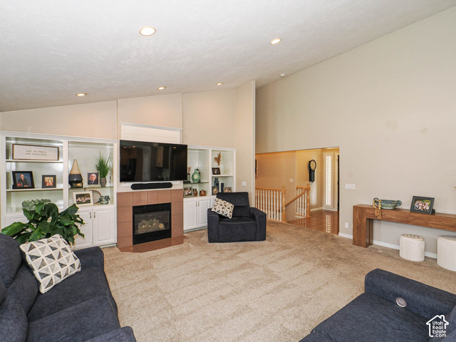 11779 South Stone Ridge Court Ridge West Riverton, UT 84065 - Photo 22 of 85 Vaulted ceiling, recessed lighting, built-in shelving, gas fireplace, and wood-finish handrailing
