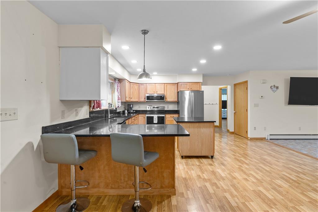 178 Christopher Road Flinton, PA 16640 - Photo 15 of 41 a kitchen with kitchen island stainless steel appliances a stove a table chairs refrigerator and a sink