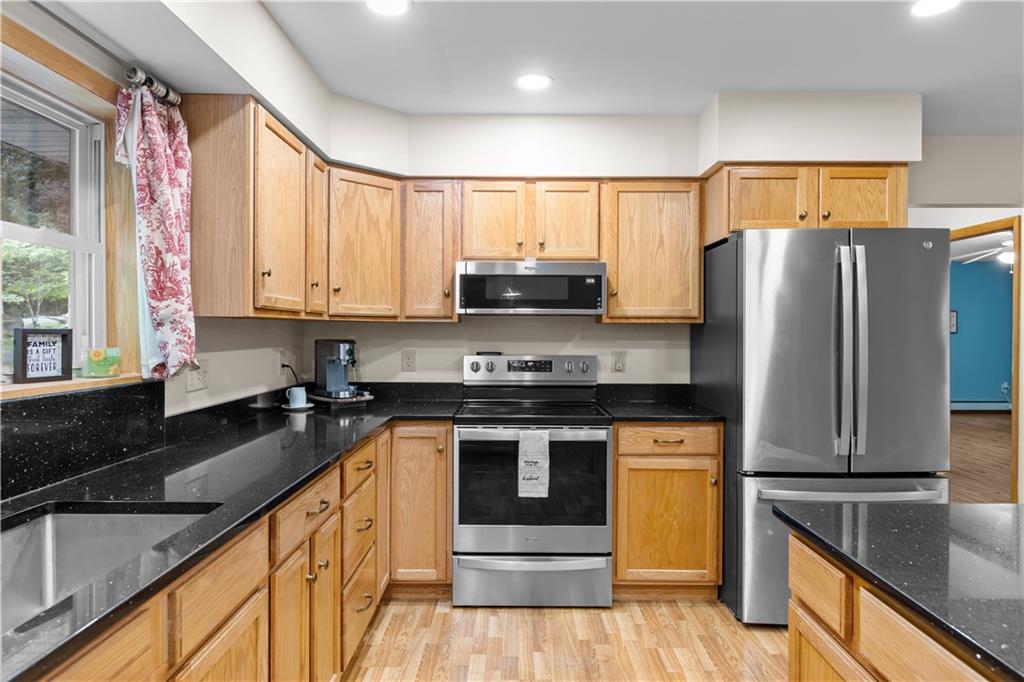 178 Christopher Road Flinton, PA 16640 - Photo 9 of 41 a kitchen with stainless steel appliances granite countertop a stove a sink and a refrigerator