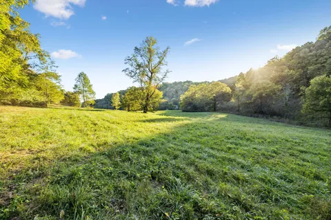 an aerial view of a house with a yard basket ball court and outdoor seating