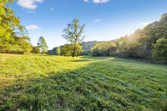 an aerial view of a house with a yard basket ball court and outdoor seating