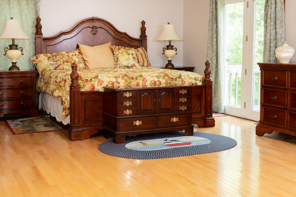 636 Lumbert Mill Road Centerville, MA 02632 - Photo 14 of 23 a bed sitting in a spacious bedroom next to a window