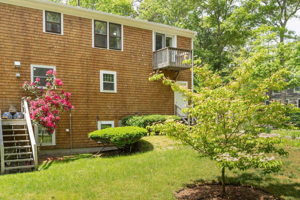 636 Lumbert Mill Road Centerville, MA 02632 - Photo 21 of 23 a view of a house with potted plants