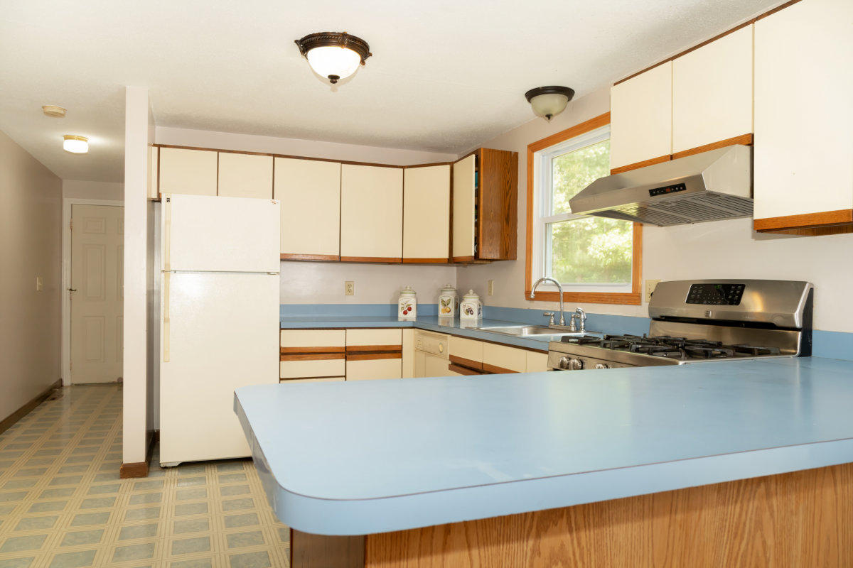 636 Lumbert Mill Road Centerville, MA 02632 - Photo 7 of 23 a kitchen with stainless steel appliances granite countertop a sink a refrigerator and a stove