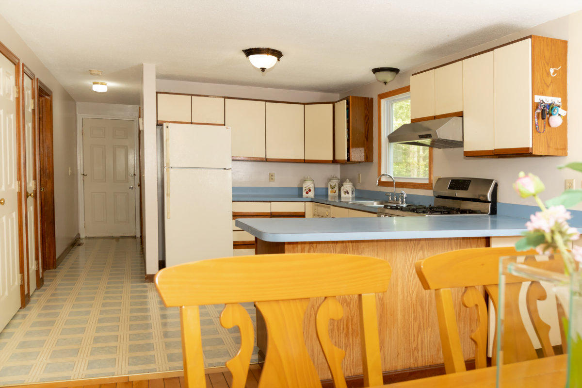 636 Lumbert Mill Road Centerville, MA 02632 - Photo 8 of 23 a kitchen with a sink a refrigerator and cabinets