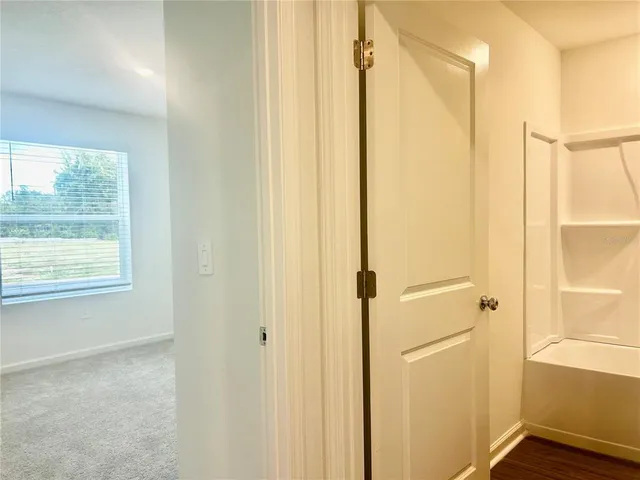a bathroom with a shower and a door
