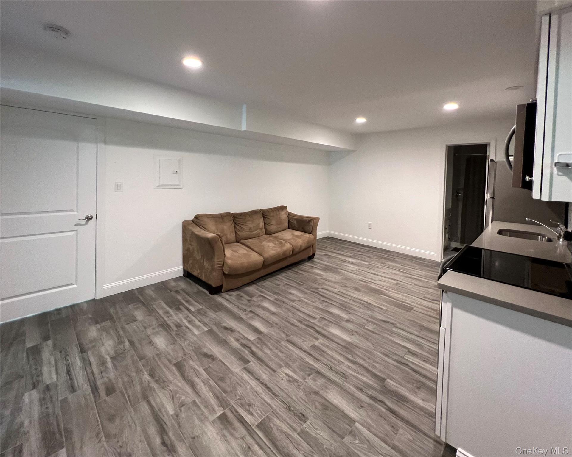 16 Albano Ridge, Unit 1 Carmel, NY 10512 - Photo 2 of 6 a living room with furniture and a wooden floor