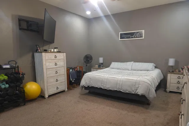 a bedroom with a bed and a window