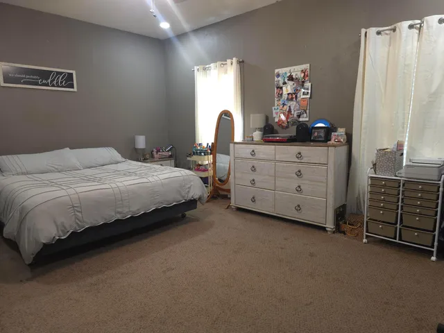 a bedroom with a bed and a tv