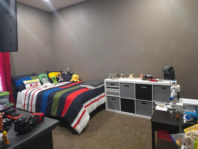 a bedroom with a bed and a dresser