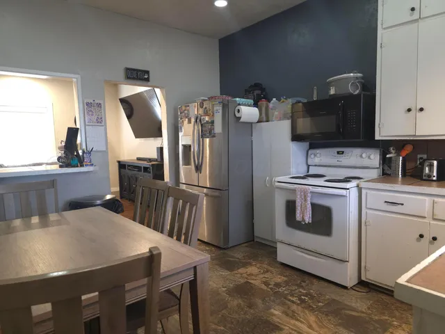 a kitchen with white cabinets and stainless steel appliances