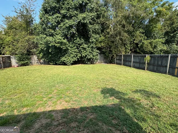 a swimming pool with trees in front of it
