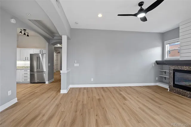 a view of empty room with wooden floor and fireplace