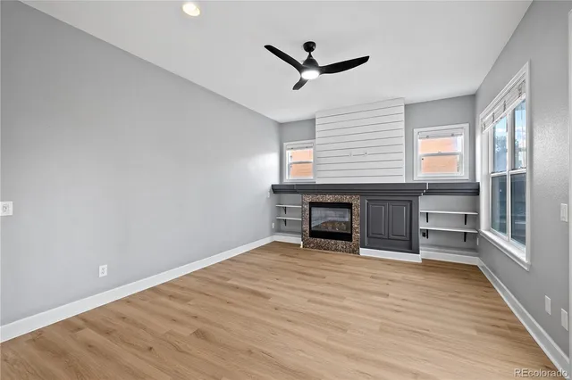 a view of a kitchen with wooden floor and a kitchen