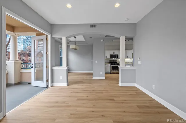 a kitchen with granite countertop a refrigerator stove and sink