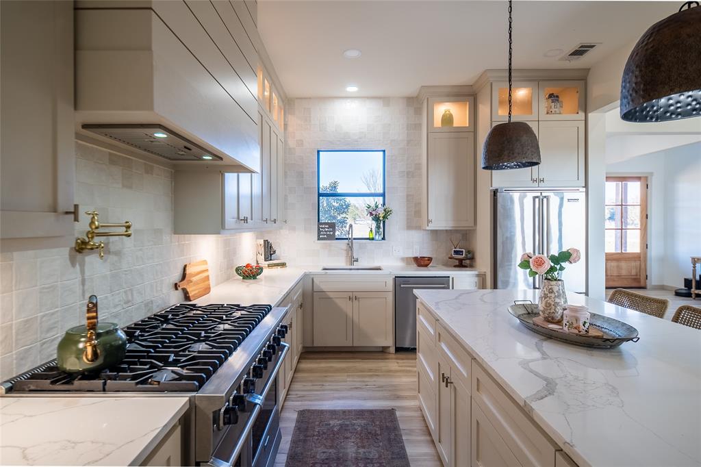 375 Wolf Front Road Van Alstyne, TX 75495 - Photo 12 of 40 a kitchen with a sink stove and cabinets