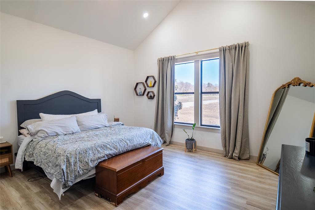 375 Wolf Front Road Van Alstyne, TX 75495 - Photo 15 of 40 a bedroom with a bed lamp and a large window