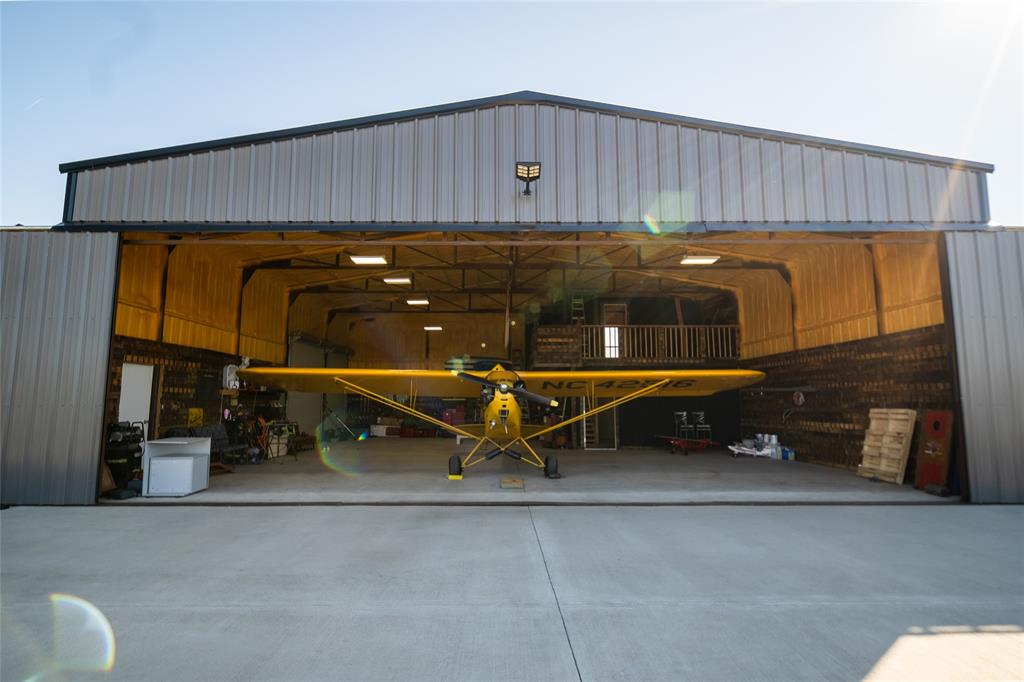 375 Wolf Front Road Van Alstyne, TX 75495 - Photo 2 of 40 a view of a car garage with a hanging chair