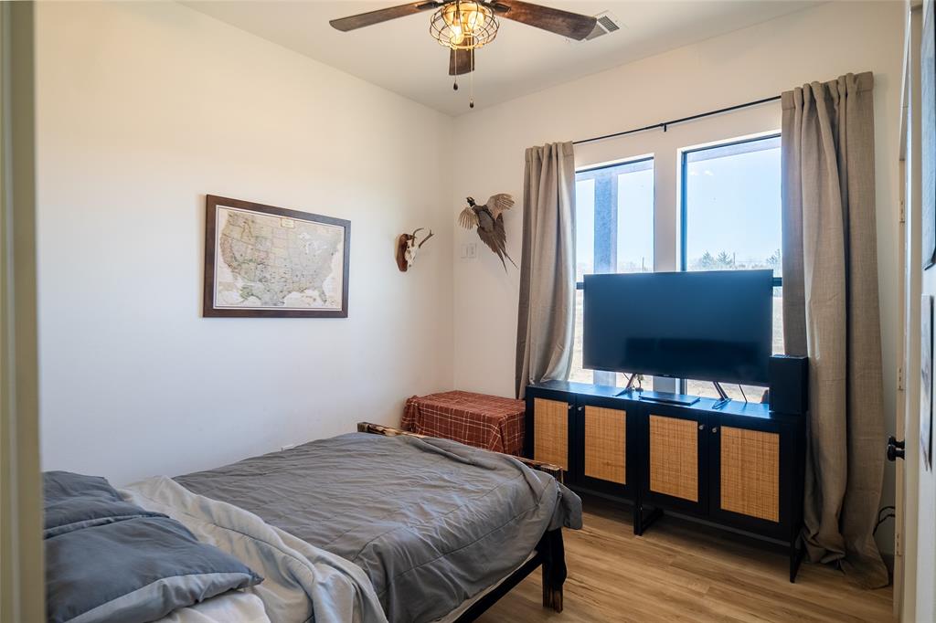 375 Wolf Front Road Van Alstyne, TX 75495 - Photo 27 of 40 a bedroom with a bed and a flat screen tv